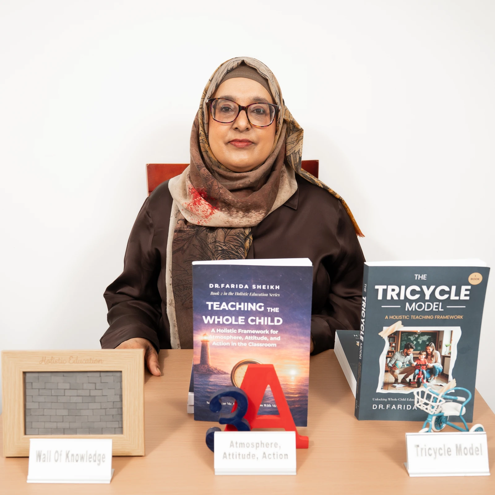 Dr Farida Sheikh with a display of education books
